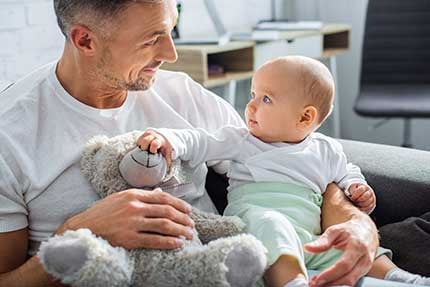 baby-playing-with-teddy-bear-430