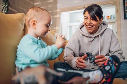 mom-and-toddler-son-playing-with-dinosaurs-toys-430-2